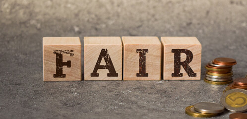 inscription fair on wooden cubes on a gray background