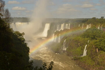A rainbow over the huge Iguazu River and Waterfalls in Brazil and Argentina