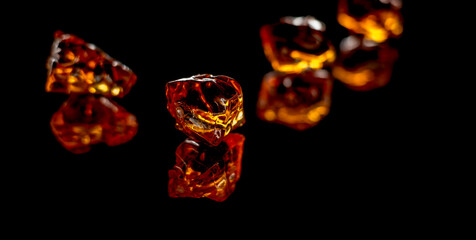Baltic amber stones rectangular lie on a black background