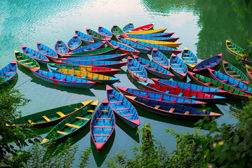 Wooden Row Boats in glacial napal lake in bright colors