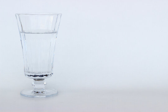 Water in the luxury glass on isolated white background with blank space
