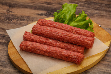 Raw beef sausages with spices