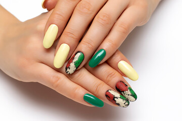Obraz na płótnie Canvas Autumn yellow, green, black, orange, cracked manicure on long oval nails close-up on a white background. Gel fashion design.