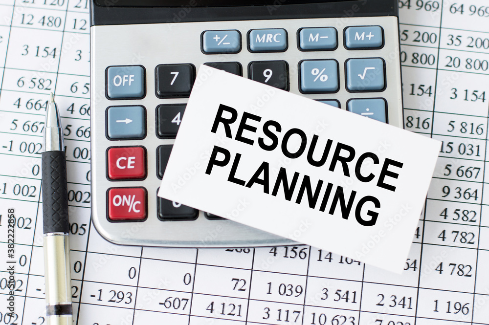 Poster resource planning text on the card lying on the calculator, as well as next to graphics with numbers