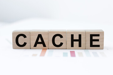 CACHE word made with building blocks located on paper charts on the table