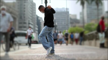Young man dancing in street wearing covid face mask - Powered by Adobe