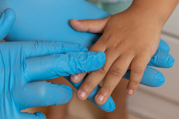 Fototapeta premium doctor taking care of child - taking hand