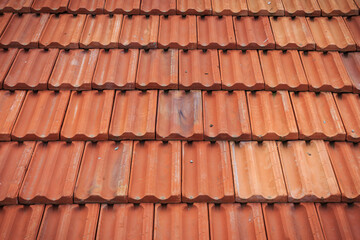Red tile in-line roof pattern on house and buildings. Tile textured background.