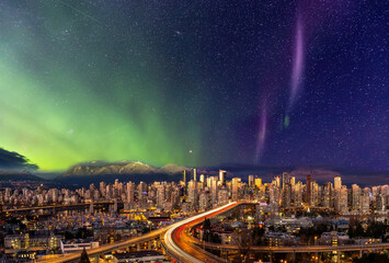 Fototapeta premium Downtown Vancouver, British Columbia, Canada. Beautiful Aerial Panoramic View of a Modern City. Cityscape Skyline. During Colorful Night with aurora borealis Composite. Dreamscape