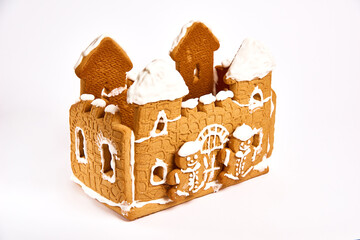 sweet gingerbread house with icing decor on white background. Concept of winter traditional dessert
