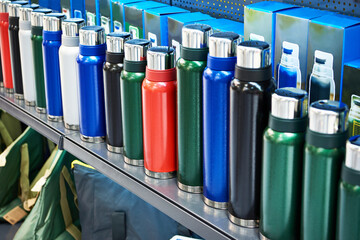 Colored vacuum flasks in shop
