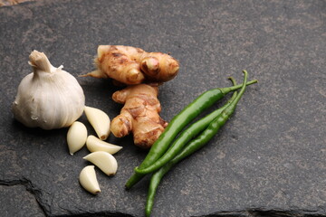 Ginger garlic chili composition isolated on black background 