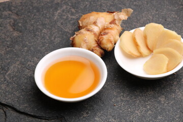 Naklejka na ściany i meble Honey in bowl and a slices ginger root.