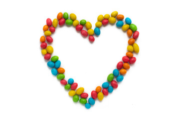 Heart made of multicolored sweets on a white background. Sweet love