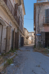 Fototapeta na wymiar Apice Vecchio, a small ghost town in the province of Benevento. Wretched houses, collapsed buildings, closed and empty squares. Broken lanterns and abandoned shops