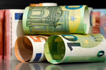 Several rolled-up Euro banknotes