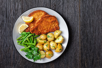 German pork schnitzel with potato and green beans