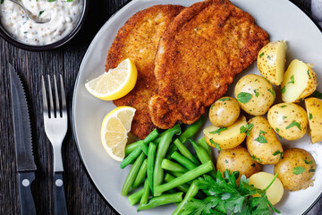 German pork schnitzel with potato and green beans