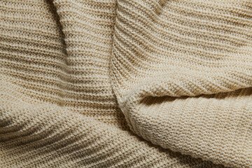 wool knitted fabric as background, beige color