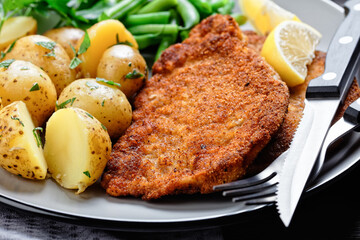 German pork schnitzel with potato and green beans