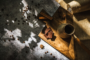 Fototapeta na wymiar coffee, chocolate, cinnamon and spices on a brown wooden board 1