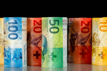 There are rolled-up Swiss banknotes