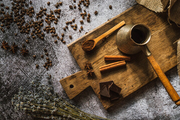 coffee, chocolate, cinnamon and spices on a brown wooden board 5