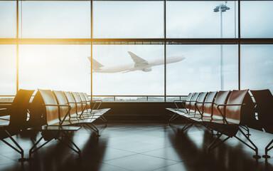 An empty waiting hall of a contemporary airport with empty rows of seats during lockdown and...