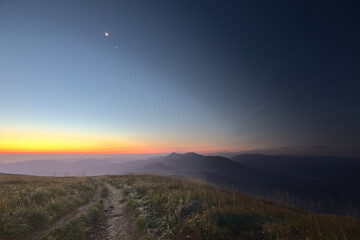 Naklejka na ściany i meble The night that gives way to the rising sun on the Smerek peak in the Bieszczady Mountains