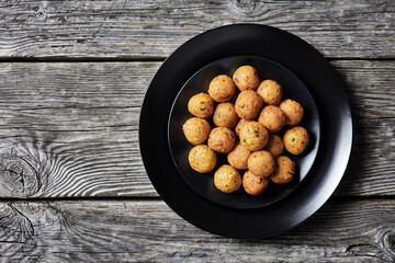 Mediterranean deep-fried falafels on a black plate