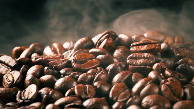 Freshly roasted coffee beans with smoke.