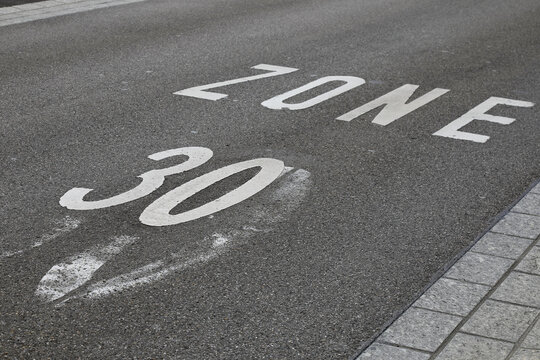 Zone with a speed limit is marked on road surface
