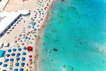 Aerial view Nissi bay beach. People, umbrellas, sand and sea wave. Famagusta District, cyprus