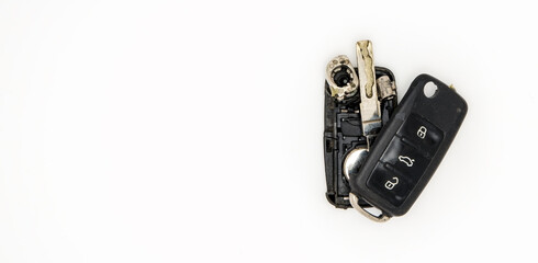 Broken or damaged remote car key fob isolated on white background flat lay banner.