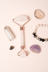Self care feminine flat lay with crystals, amethyst, jade roller symbolizing balance
