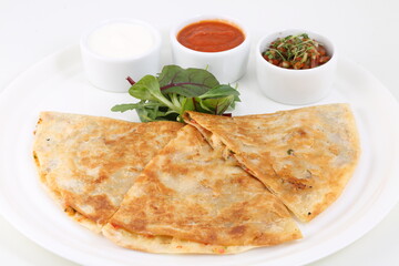 Tortillas with meat and cheese served with sauce

