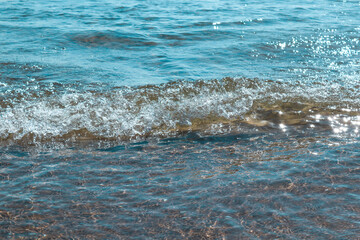 water in the sea
Texture of a sea wave with highlights and reflection on the coast, close-up side view.