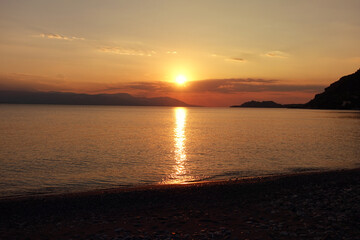 Beautiful sunset over Aegean sea as seen from Santorini island, Cyclades, Greece