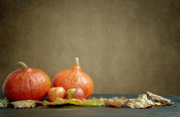 Autumn still life with pumpkin and autumn leaves. Background