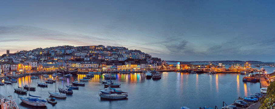 An atmospheric dusk view over the quintessential fishing harbour of Brixham, in Torbay, Devon, England, United Kingdom