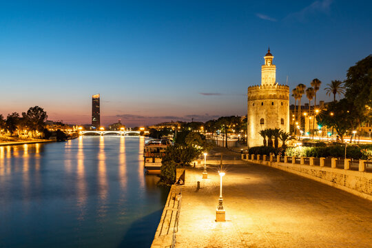Sunset at Torre del Oro (Tower of Gold), a watchtower on the bank of the Guadalquivir River in Seville, Andalusia, Spain