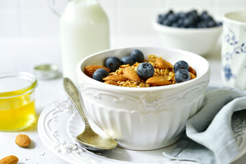 Homemade granola with milk,fresh berries and honey.