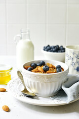 Homemade granola with milk,fresh berries and honey.