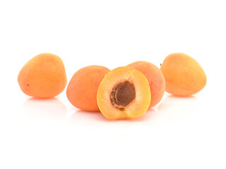 Apricots on white reflective background. Cuted apricots. Isolated