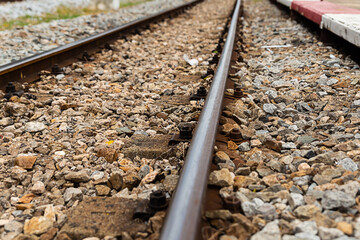 Railway track running away into the distance, iron rail on gravel background