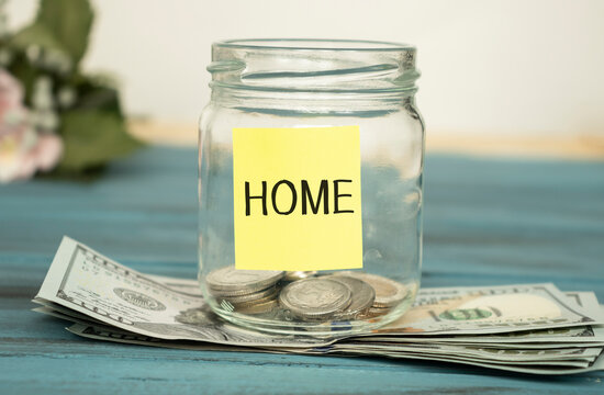 Saving money jar with label saying 'new house'