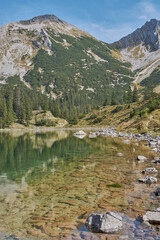 Beautiful mountain lake in the bavarian alps. Panoramic mountain landscape with a reflecting mountain lake.