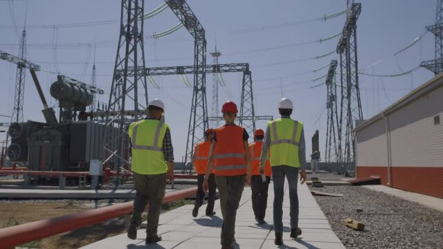 Anonymous team walking on power station