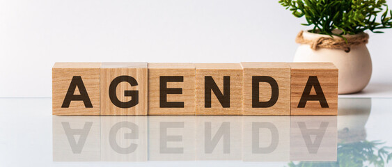 Agenda motivation text on wooden blocks business concept white background. Front view concepts,...