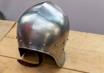 iron helmet round and lightweight stands on a wooden table
